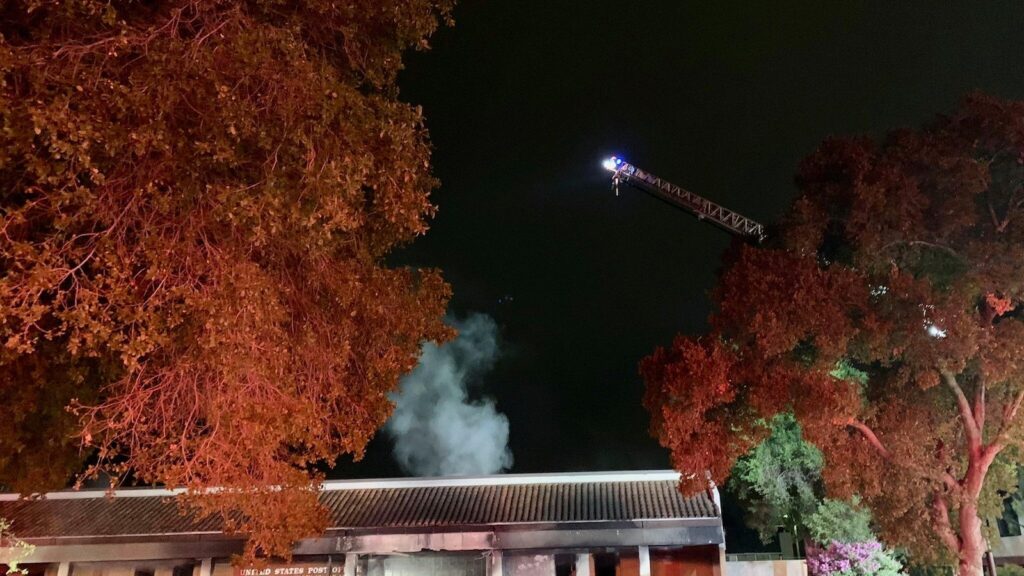 Suspect arrested after car crashes into post office and catches fire