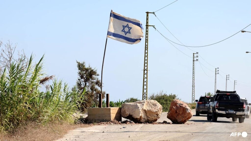 In south Lebanon, Israel flag and checkpoint mark start of occupation